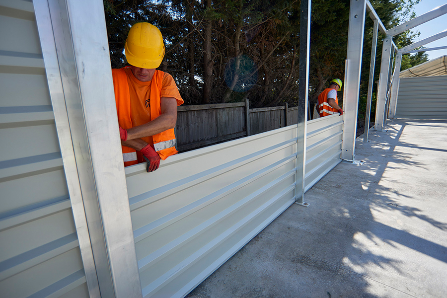 Temporary Warehouse Building Installation of steel sheet walling