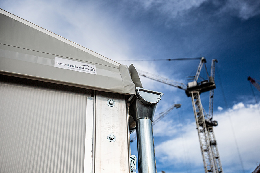 Temporary building with guttering and downpipes